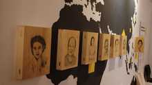 Foto der Ausstellung des Museum der Trostfrauen. Zu sehen sind die Bleistiftzeichnungen auf Holz. Abgebildet sind die Frauen, deren Geschichte im Museum erzählt wird.