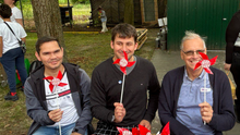 Foto vom Stand der Fraktion DIE LINKE. in der BVV Berlin-Mitte beim Sommerfriedensfest. Zu sehen sind Samiullah Haidary, Leonard Diederich und Rüdiger Lötzer mit DIE LINKE. Windrädern. 