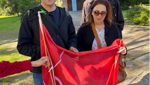 Gruppenfoto: Die Bezirksverordneten Deniz Seyhun, Rüdiger Lötzer und Leonard Diederich halten eine Fahne des DGB Kreisverbands Mitte.